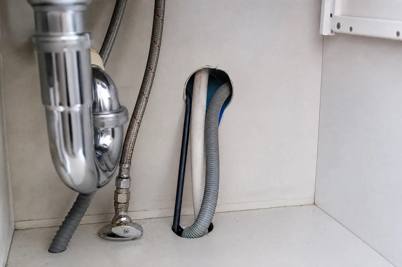 Condo kitchen plumbing wall with utility openings that can connect neighboring units